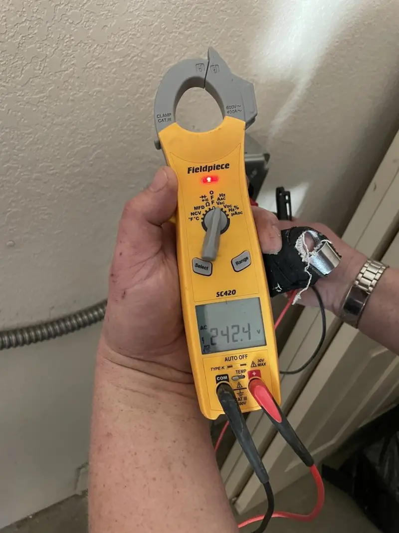 Voltage testing with clamp meter during Outlet Installation in Siloam Springs
